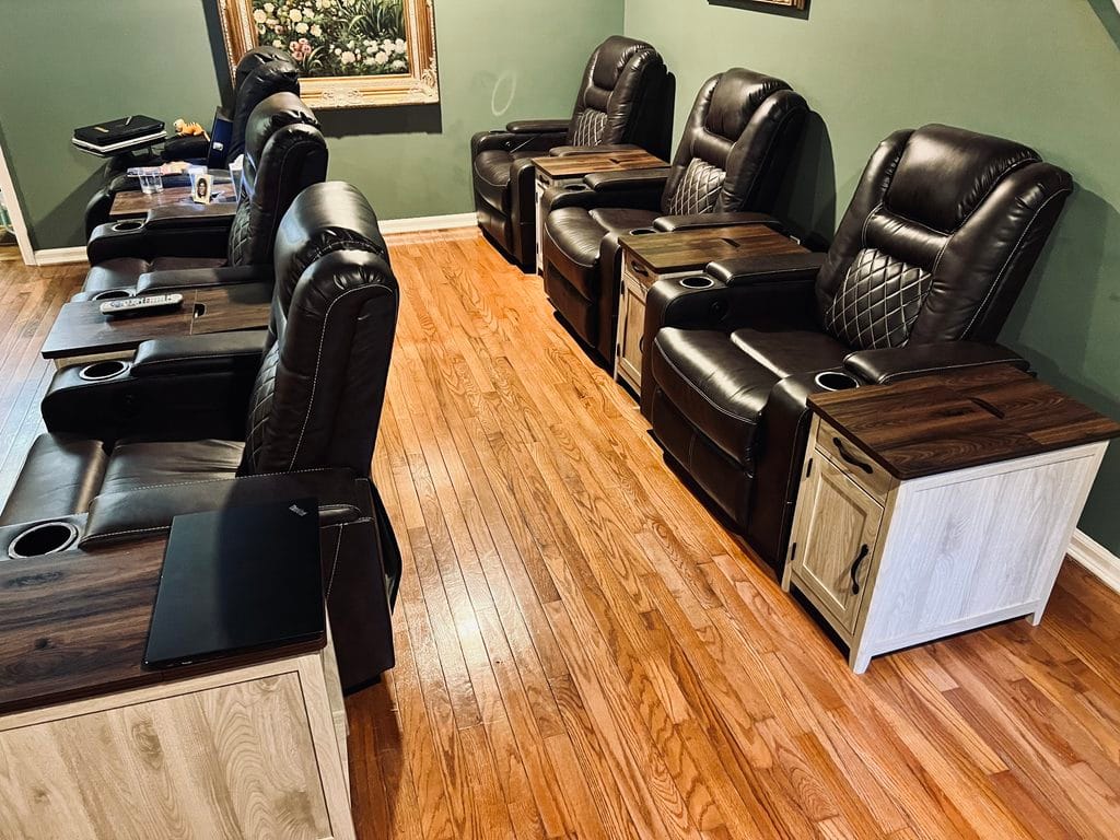Two rows of recliners and narrow charging tables arranged in our family room
