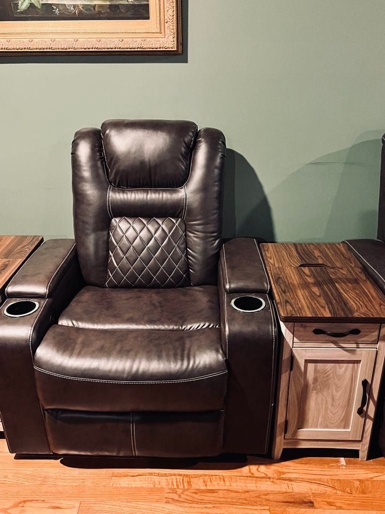 Brown power recliner beside a narrow charging end table in our family room
